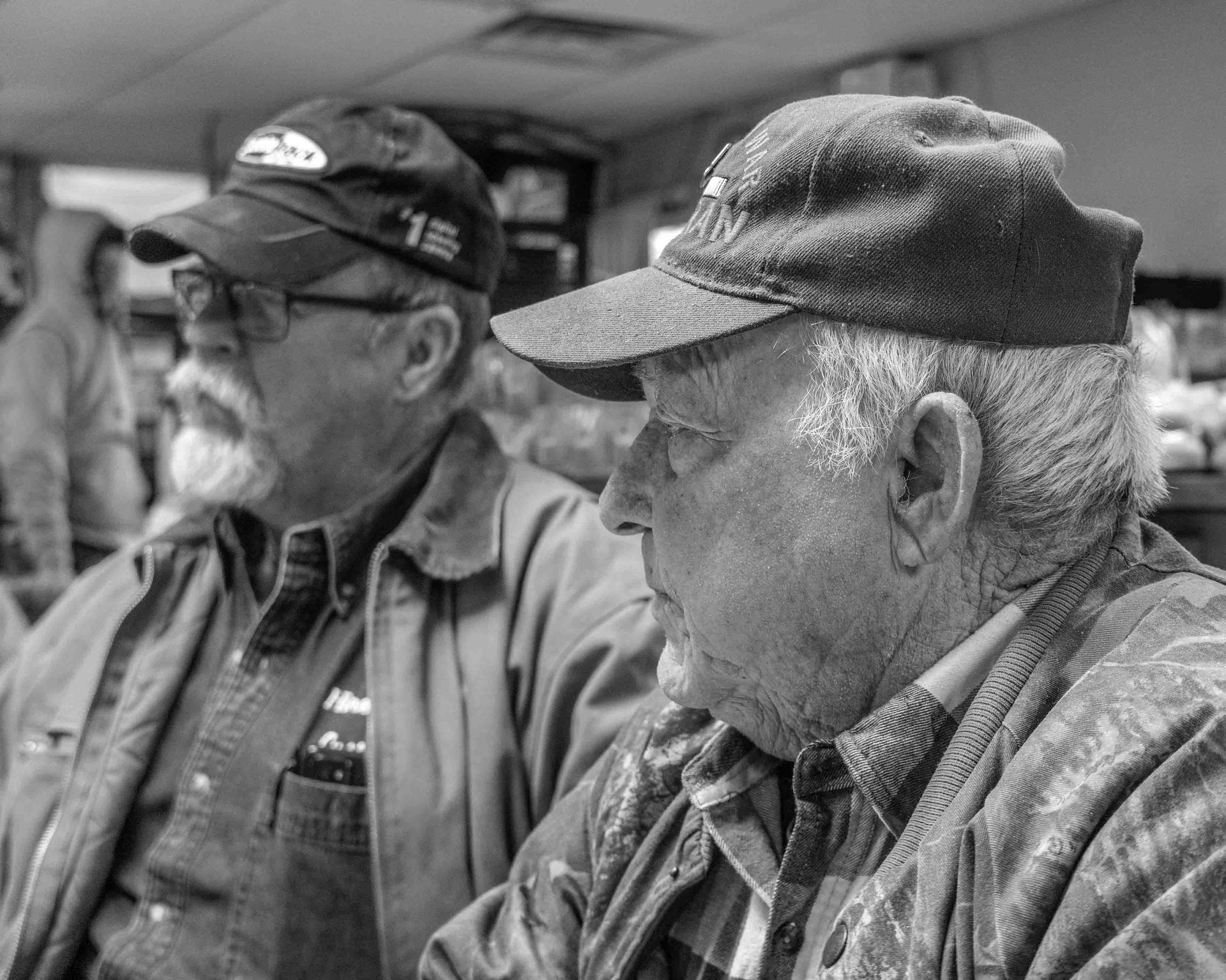 Facial hair, Monochrome photography, Eyewear, Wrinkle, Hat, Headgear, Cap, Jacket, Beard, Moustache