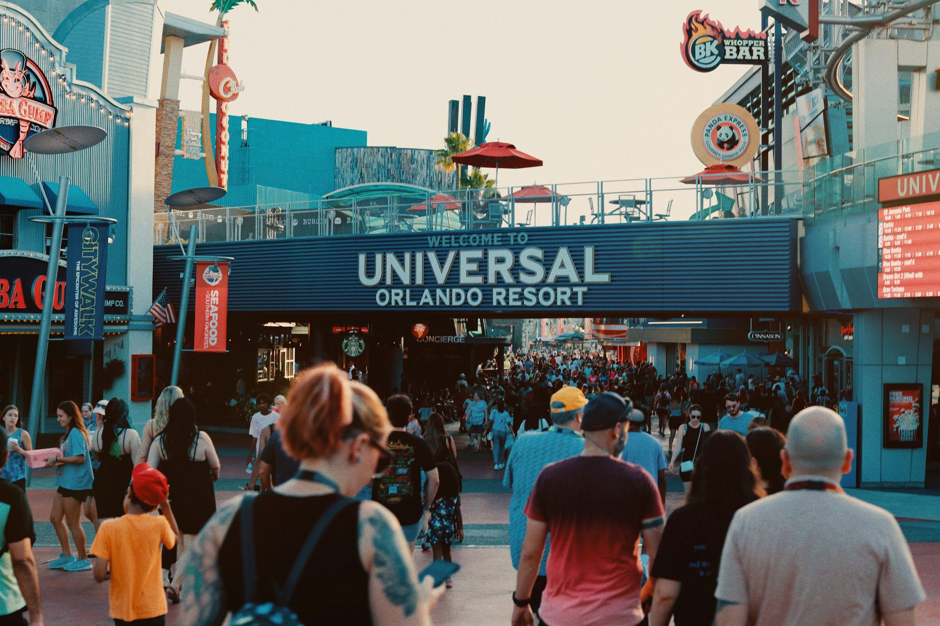 Crowded entrance of Universal Orlando Resort with its prominent welcome sign.