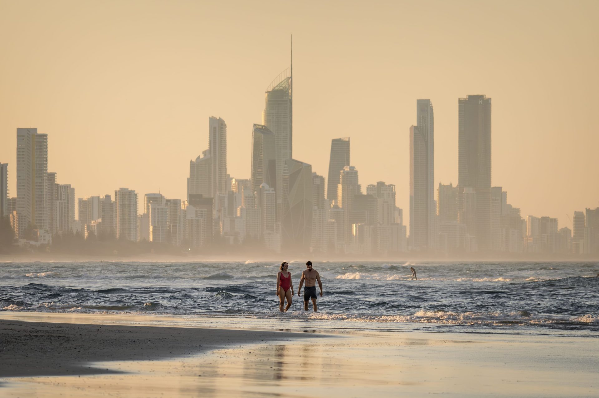 People on beach, Water, Sky, Skyscraper, Daytime, Building, Afterglow, Dusk, Sunlight
