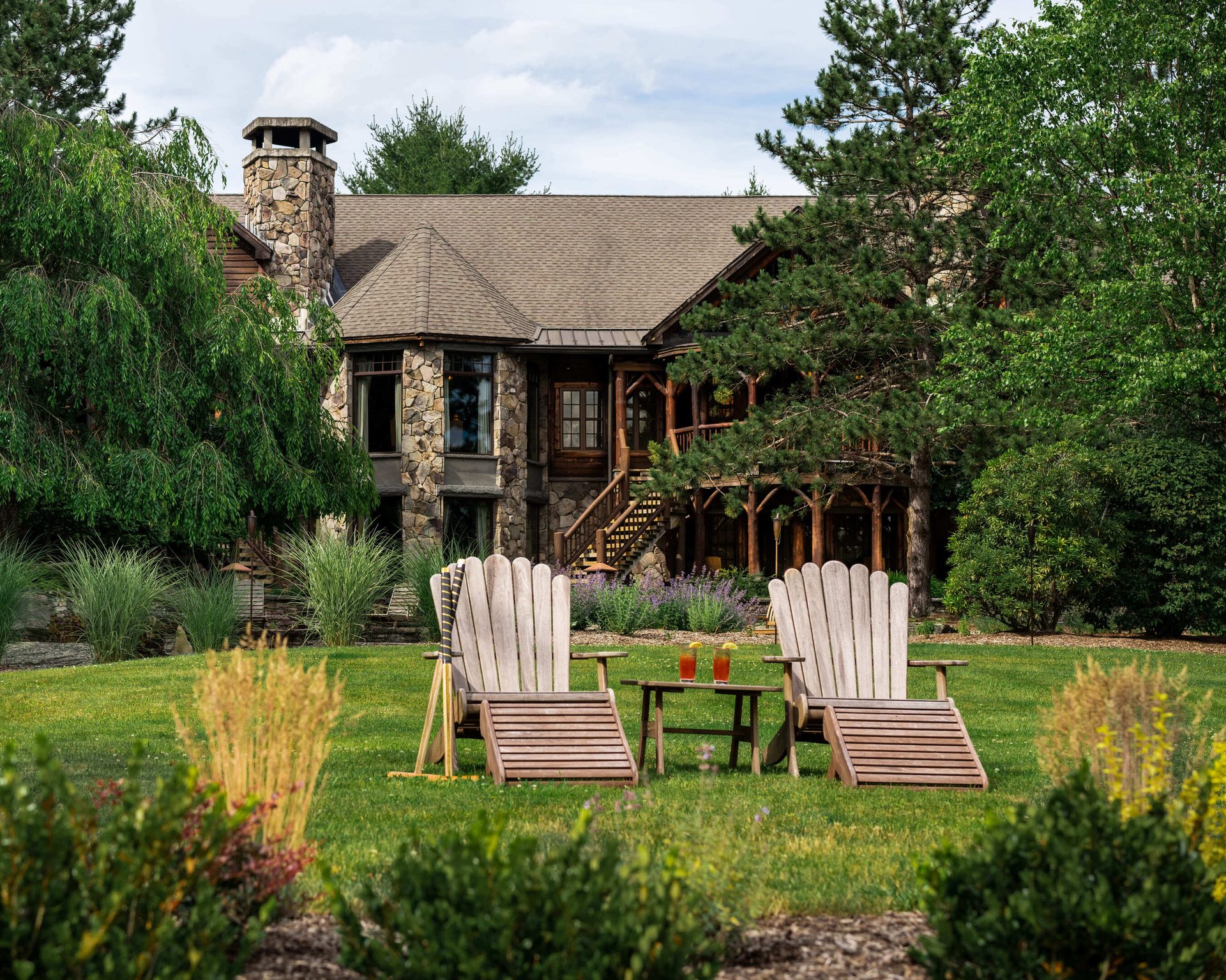 Outdoor bench, Natural landscape, Plant, Sky, Property, Furniture, Building, Tree, Window, Cloud