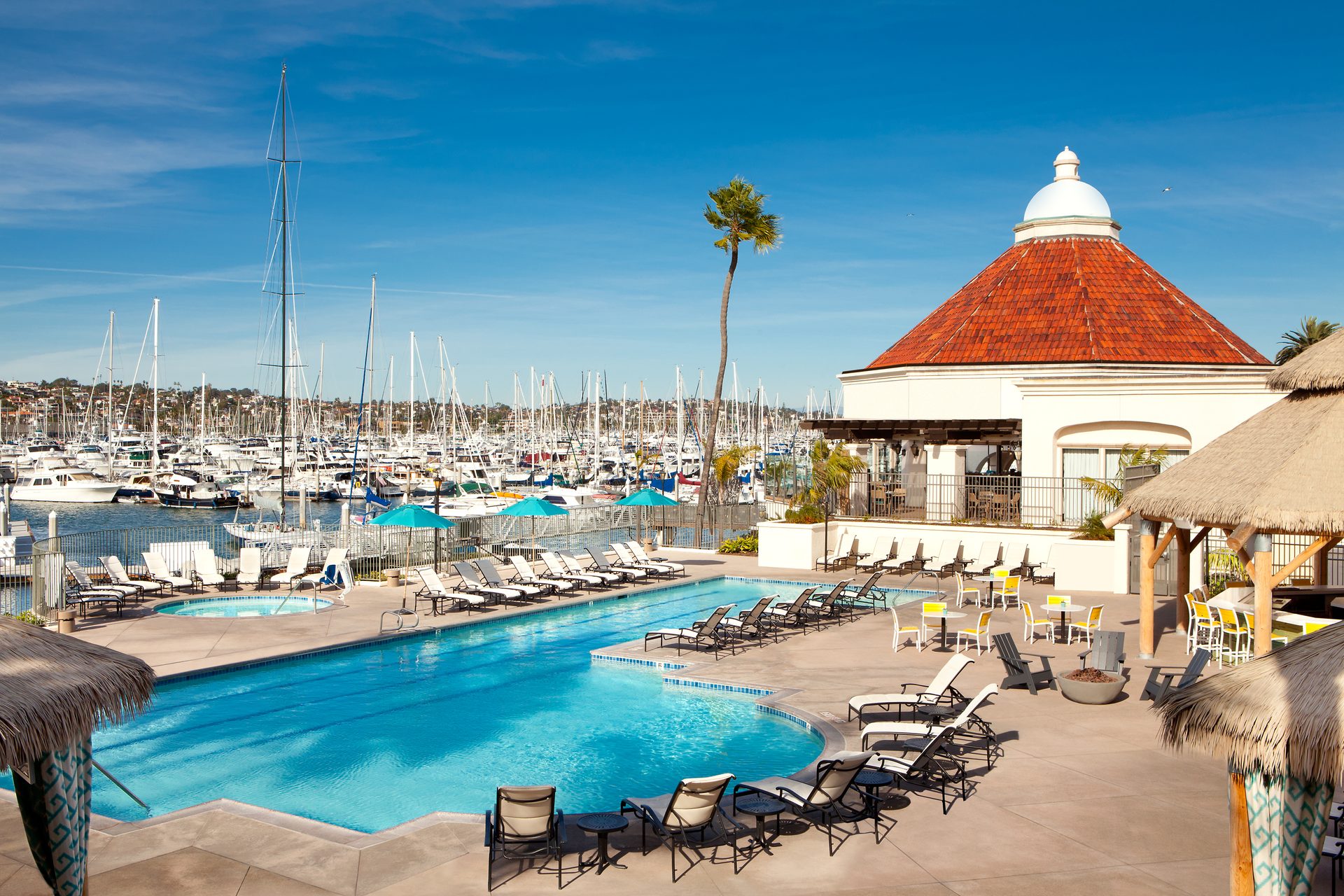 Body of water, Swimming pool, Seaside resort, Outdoor furniture, Sky, Property, Cloud, Building, Travel