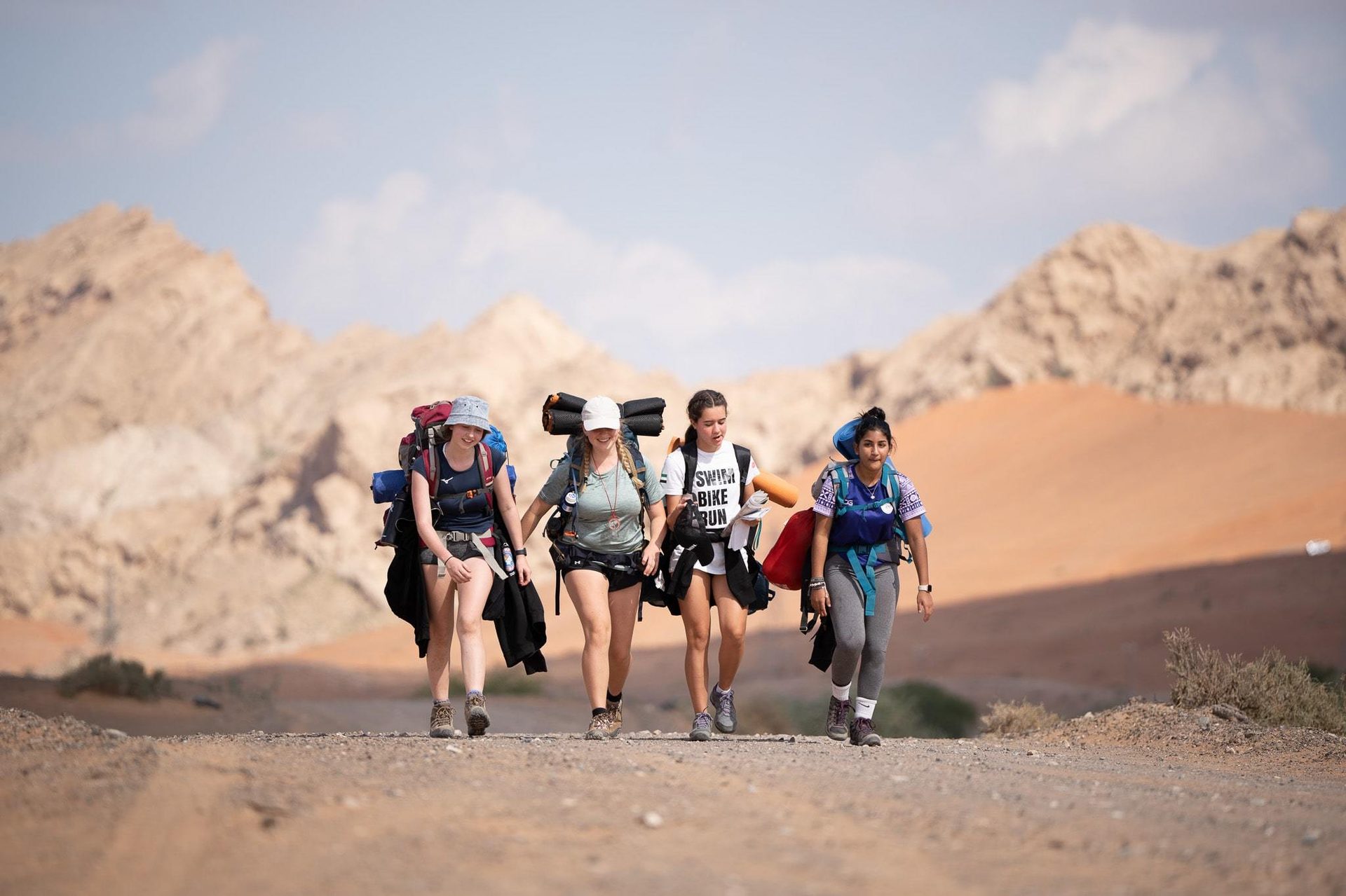 Luggage and bags, People in nature, Outdoor recreation, Cloud, Shorts, Sky, Mountain, Travel, Backpack