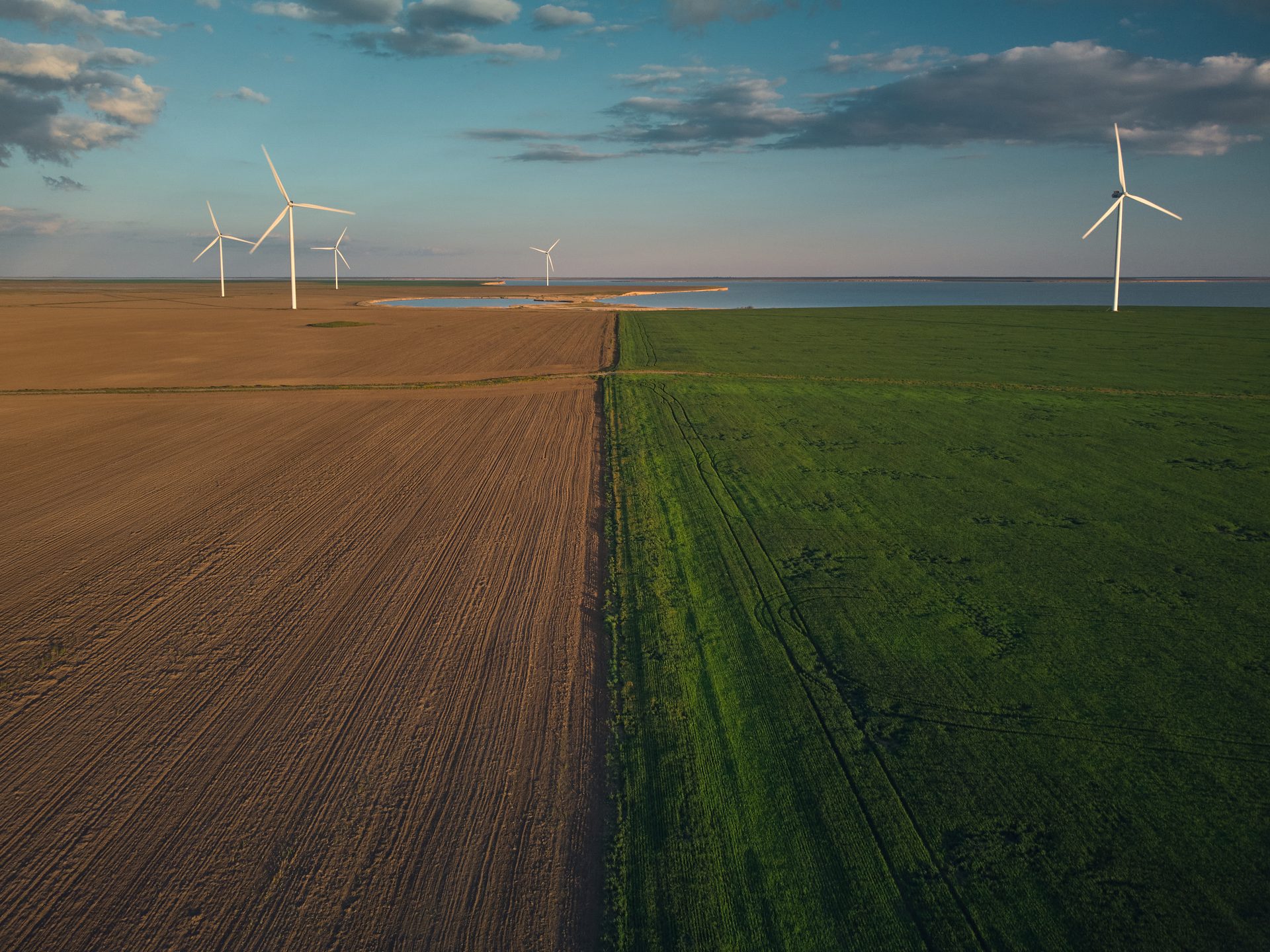 Natural landscape, Wind farm, Cloud, Sky, Windmill, Atmosphere, Ecoregion, Light, Plant, Nature