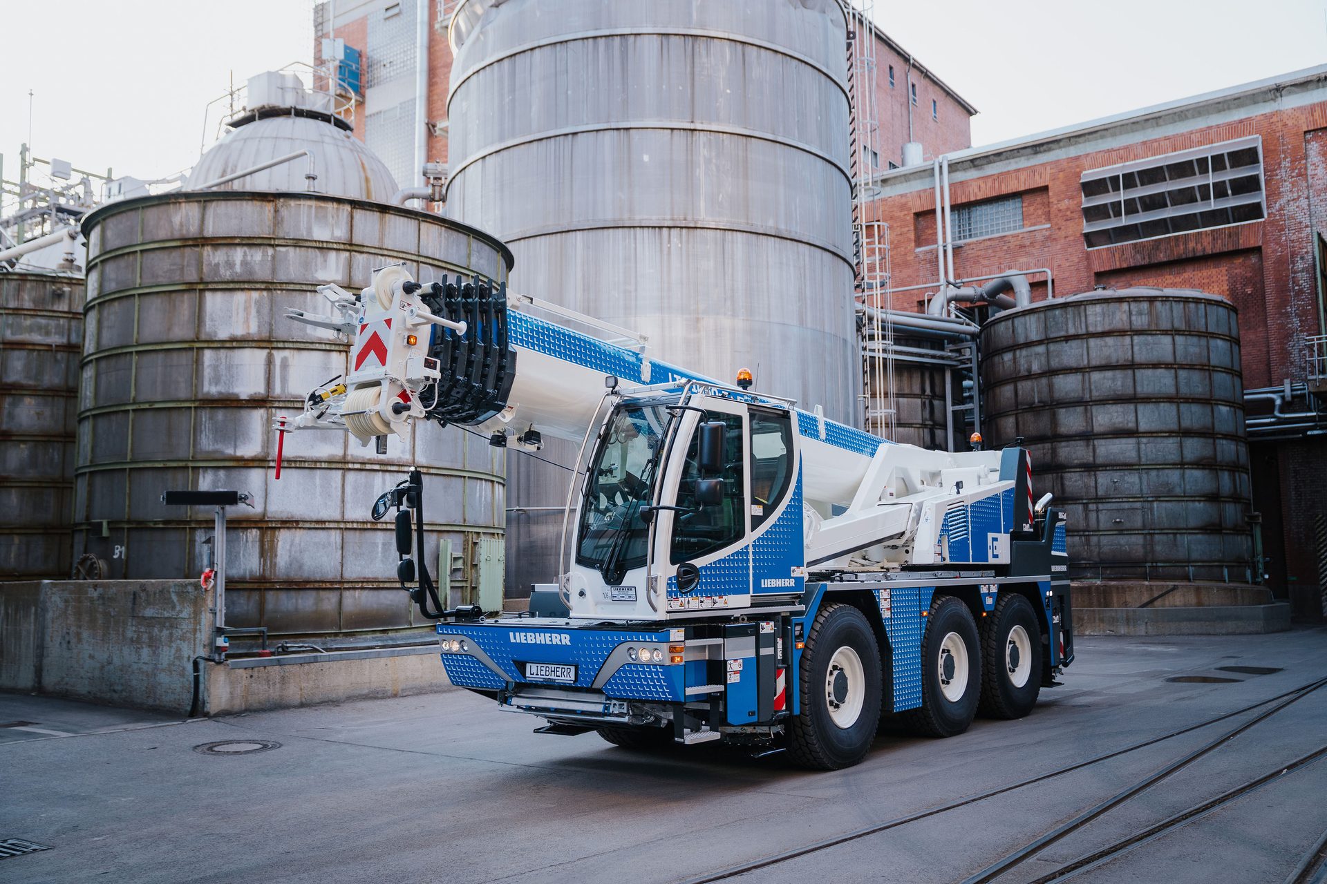 Automotive tire, Wheel, Building, Vehicle, Infrastructure, Truck, Sky, Asphalt, Silo
