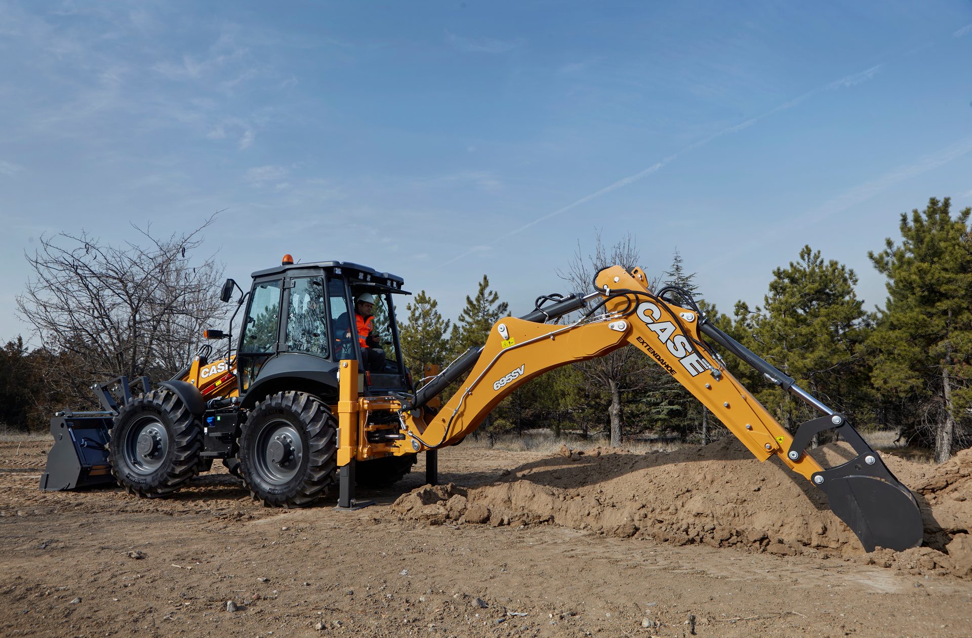 Automotive tire, Motor vehicle, Road surface, Sky, Wheel, Tree, Asphalt, Bulldozer