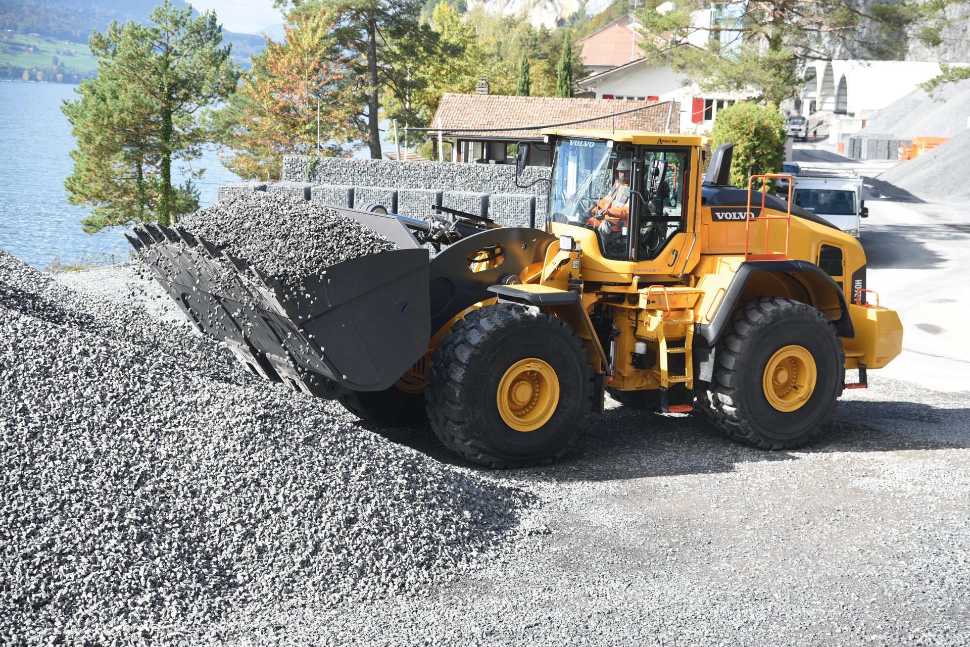 Automotive tire, Motor vehicle, Road surface, Wheel, Tread, Tree, Asphalt, Bulldozer