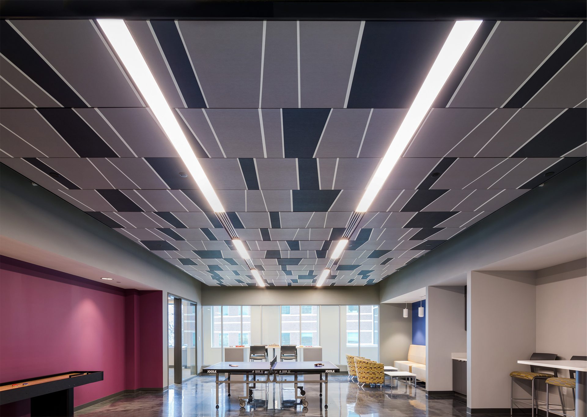 Interior of a bright colored activity room with modern custom ceiling system.