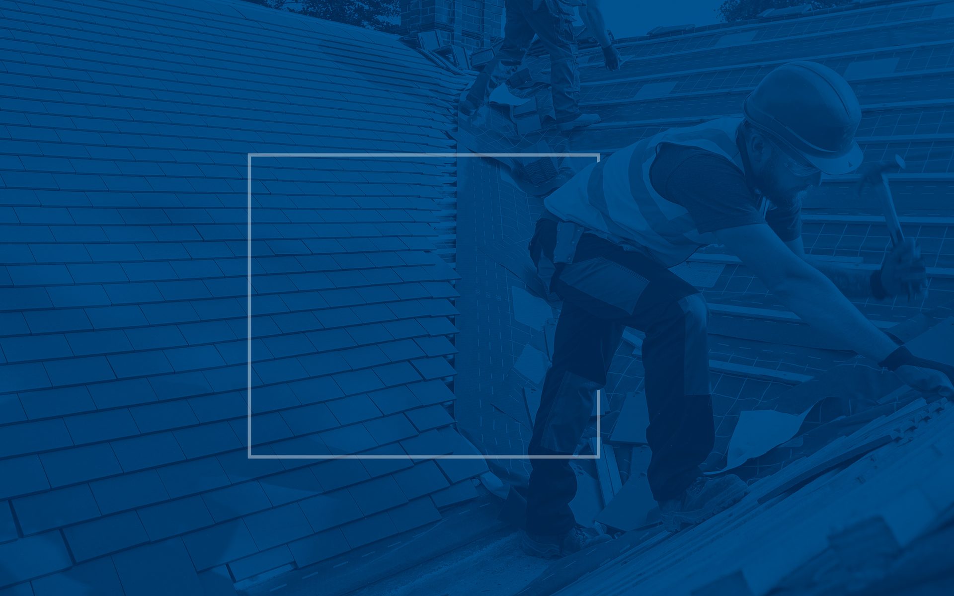 Two construction workers on a blue-tinted roof, one hammering.