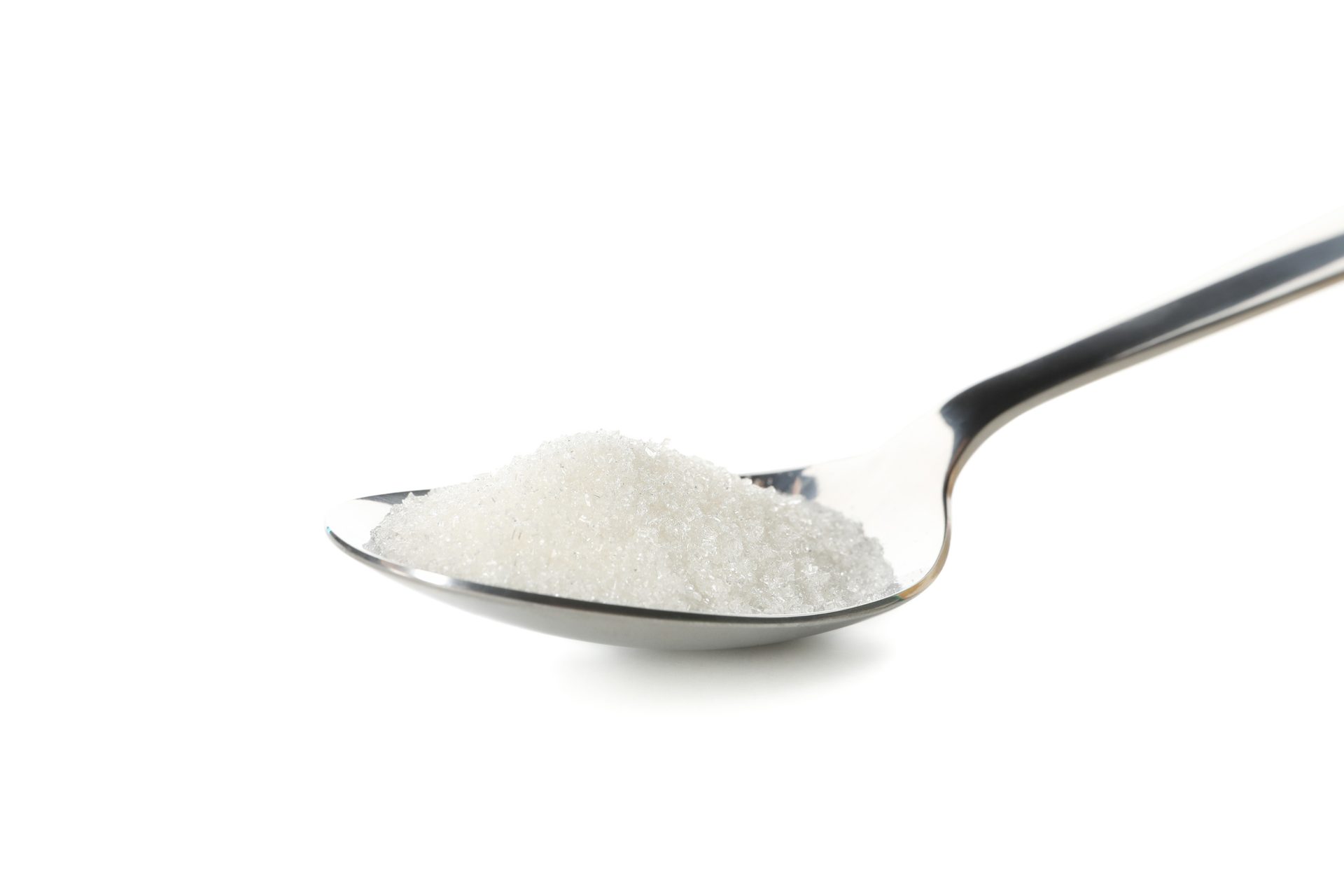 silver spoon of white sugar on a white background