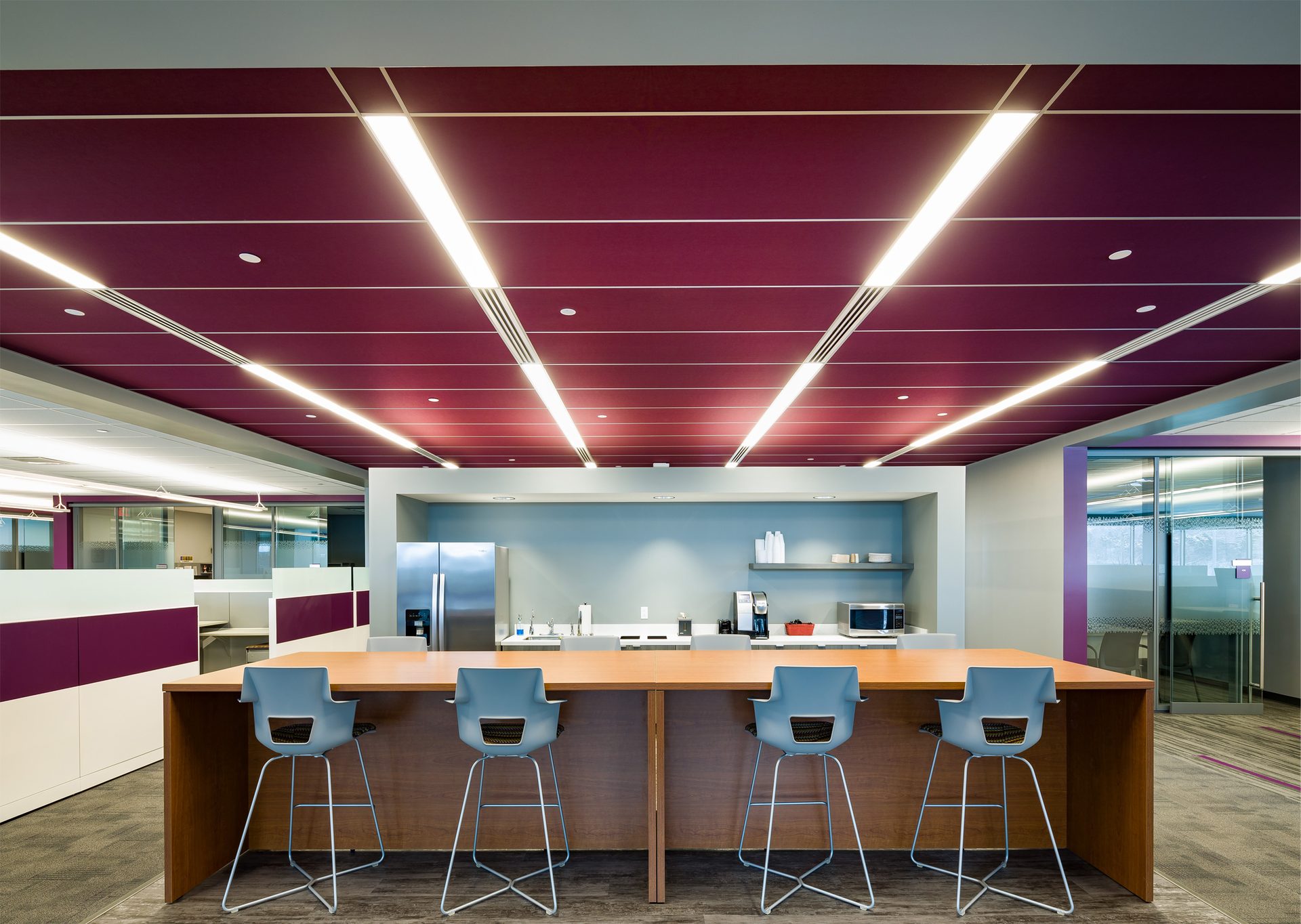 Office lunch room with deep burgundy red ceiling system.