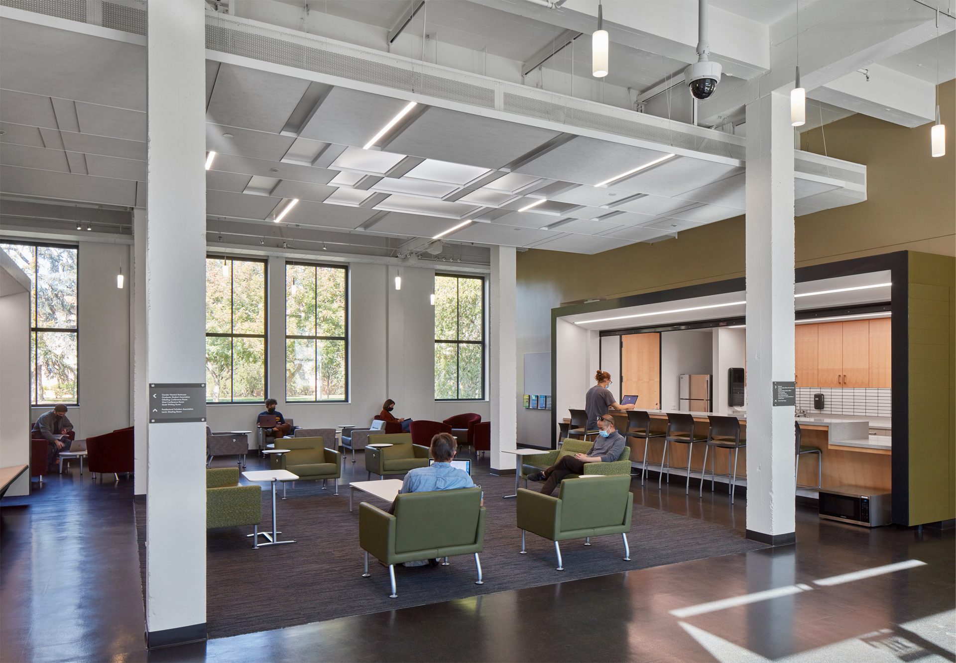 University graduate center lounge interior with staggered modern white ceiling system.