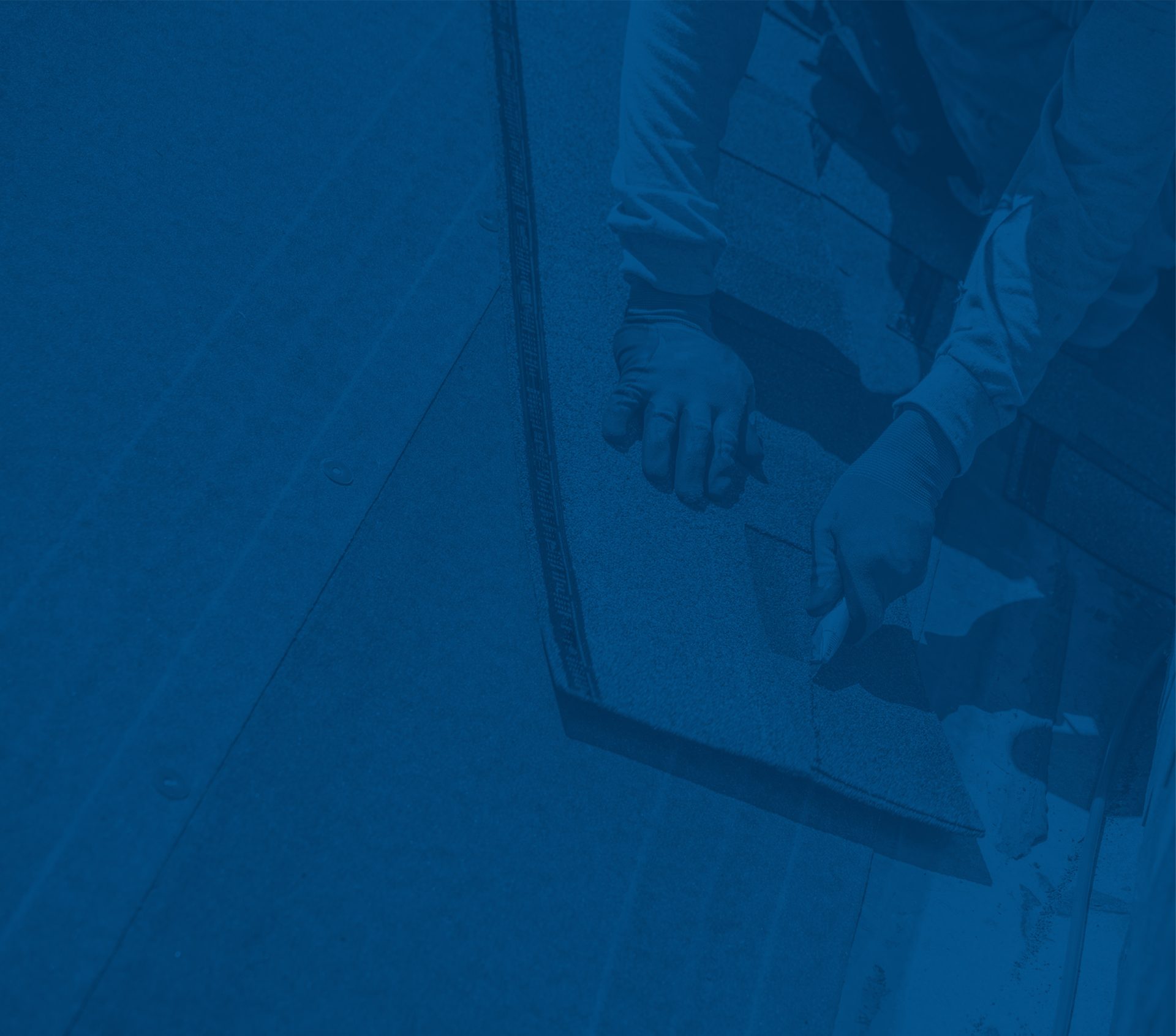 Gloved hands installing blue-tinted roof shingles. Watermarked by Getty Images.