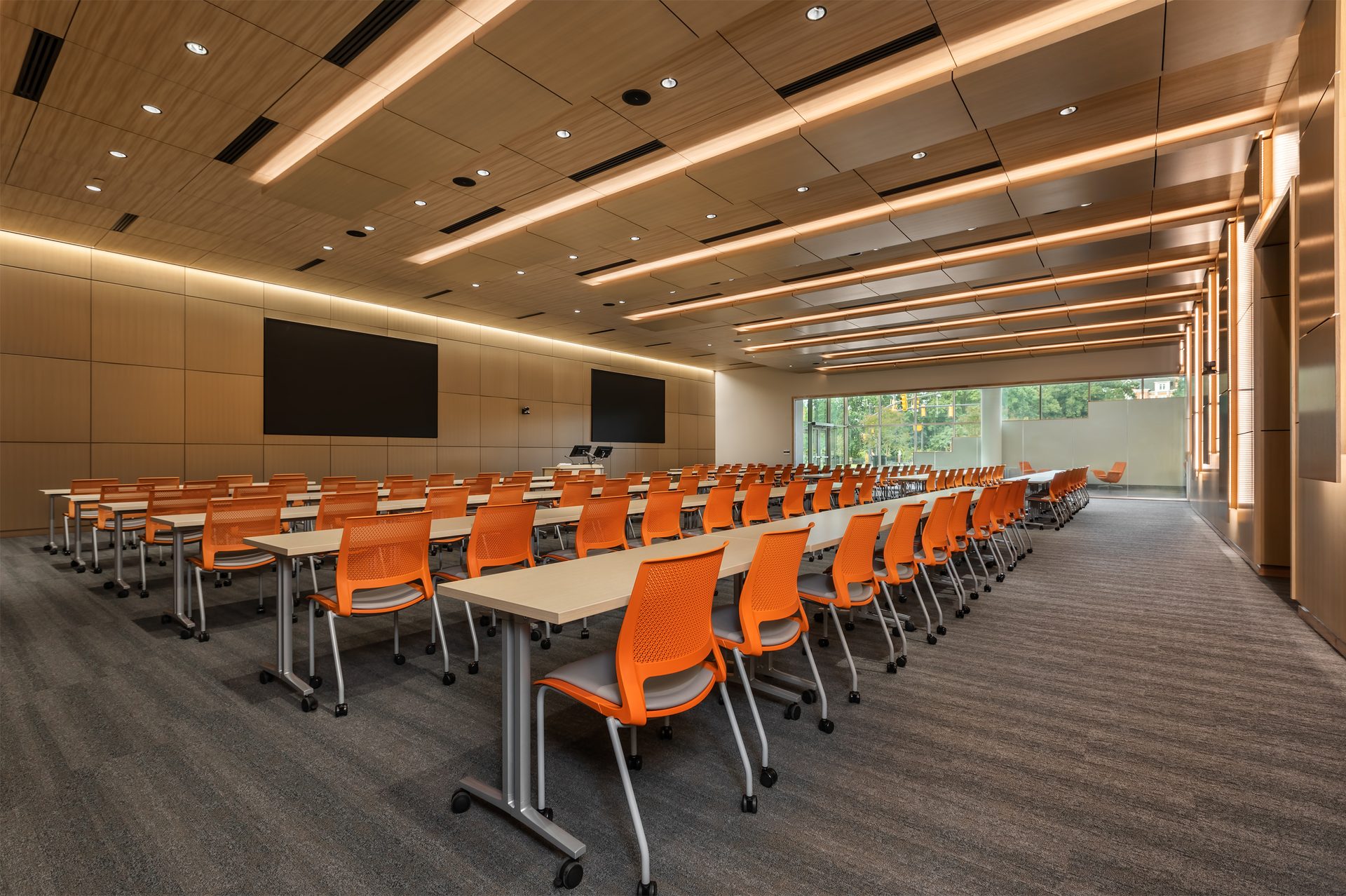 Bright interior of a conference room with a light wood finish ceiling system.