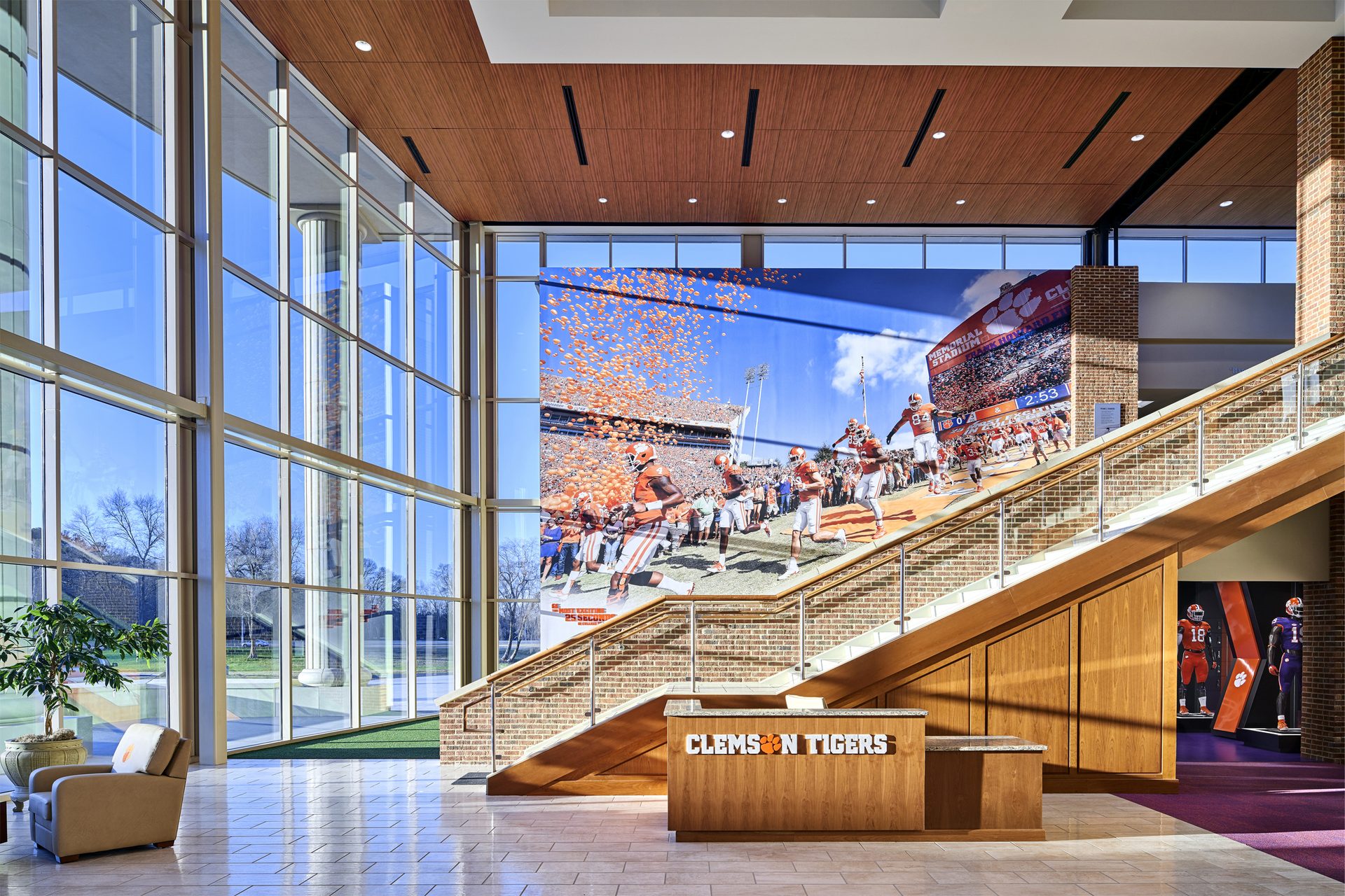 Interior design of a university campus building with a modern wood finish ceiling system.