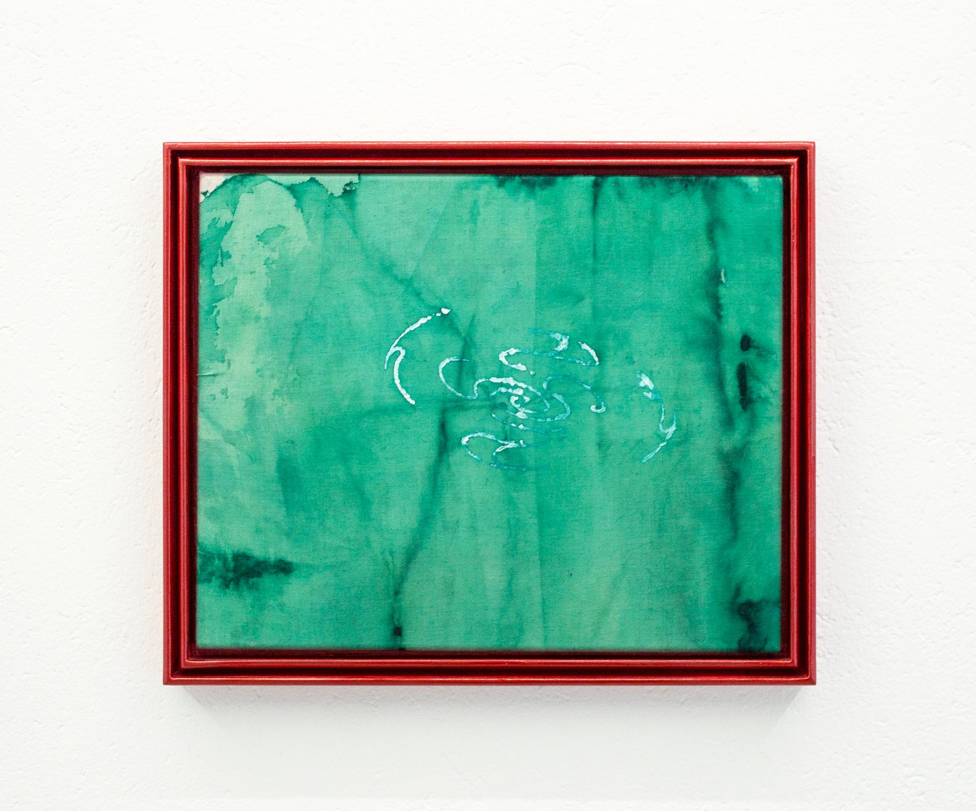 Red-framed abstract green artwork with light blue swirls on a white wall.