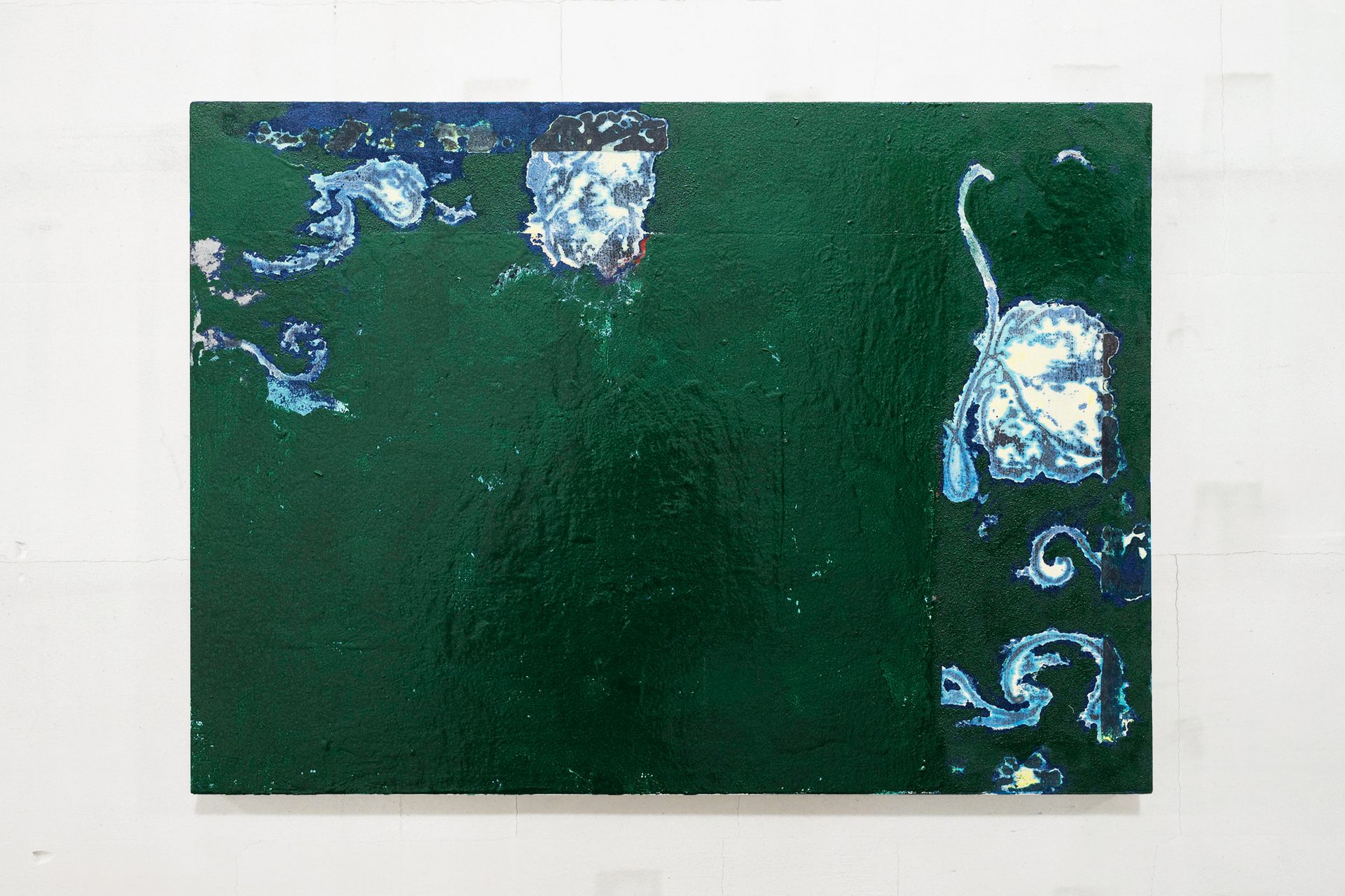 An abstract painting with a textured dark green background featuring swirls and plant-like shapes in blue and white.