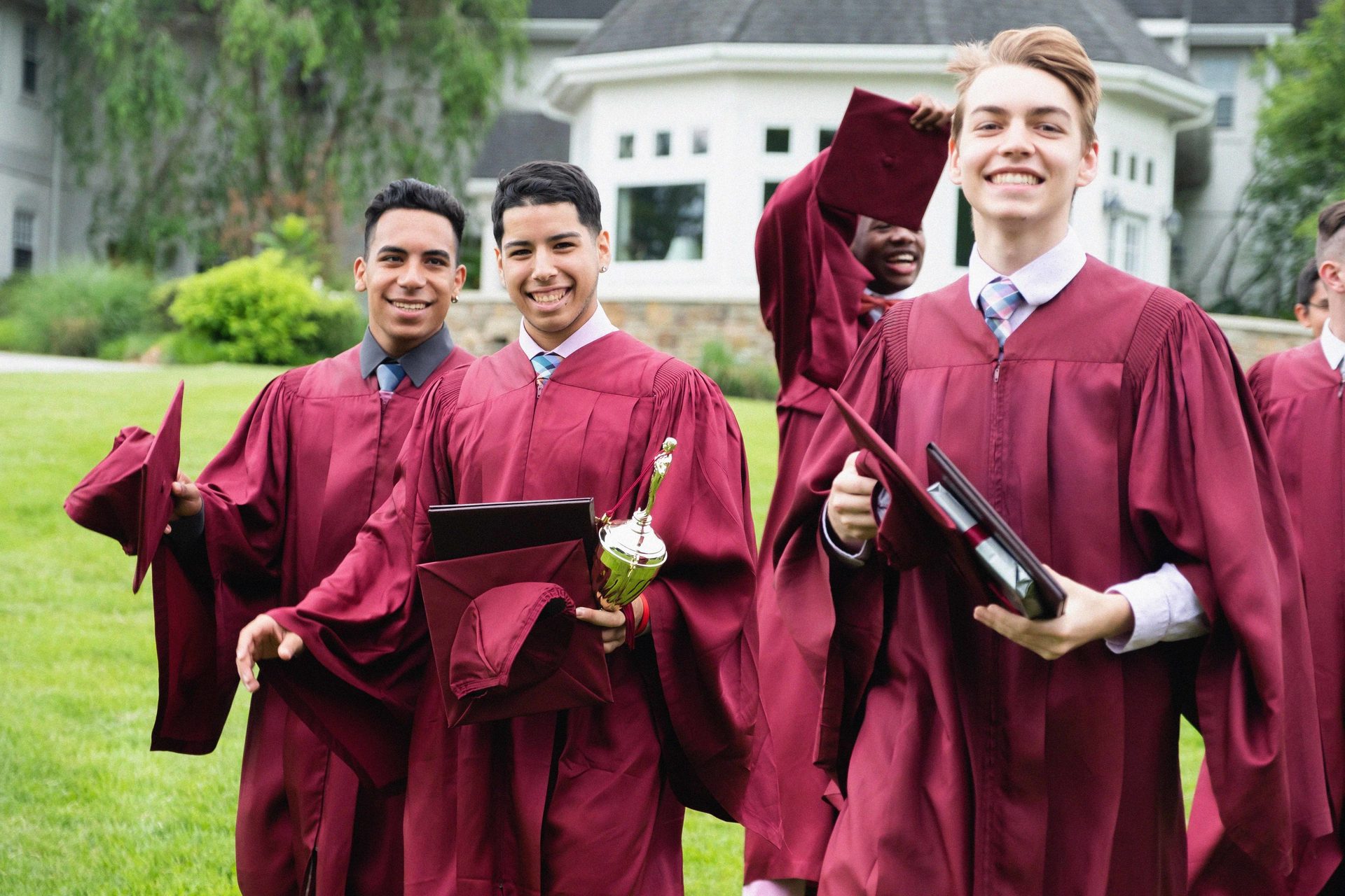 Academic dress, Social group, Smile, Scholar, Purple, Sleeve, Plant, Hat, Gesture, Window