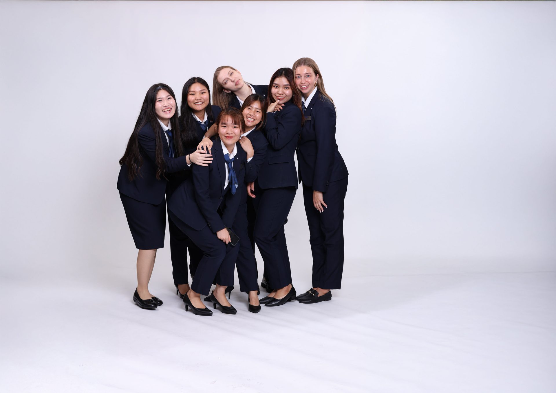 Formal wear, Social group, Facial expression, White-collar worker, Sleeve, Smile, Collar, Uniform, Happiness, Team