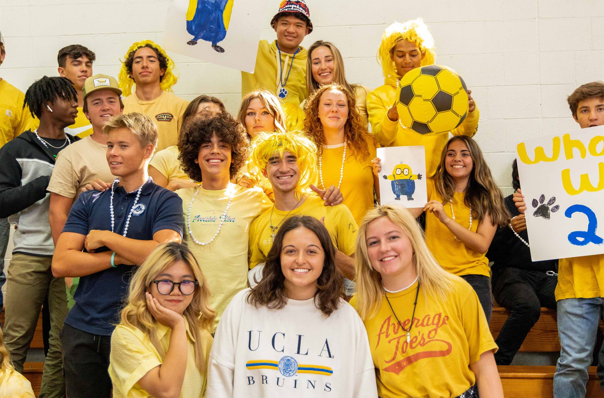 Social group, Clothing, Smile, Hair, Yellow, Orange, Happy, T-shirt, Gesture, Sleeve