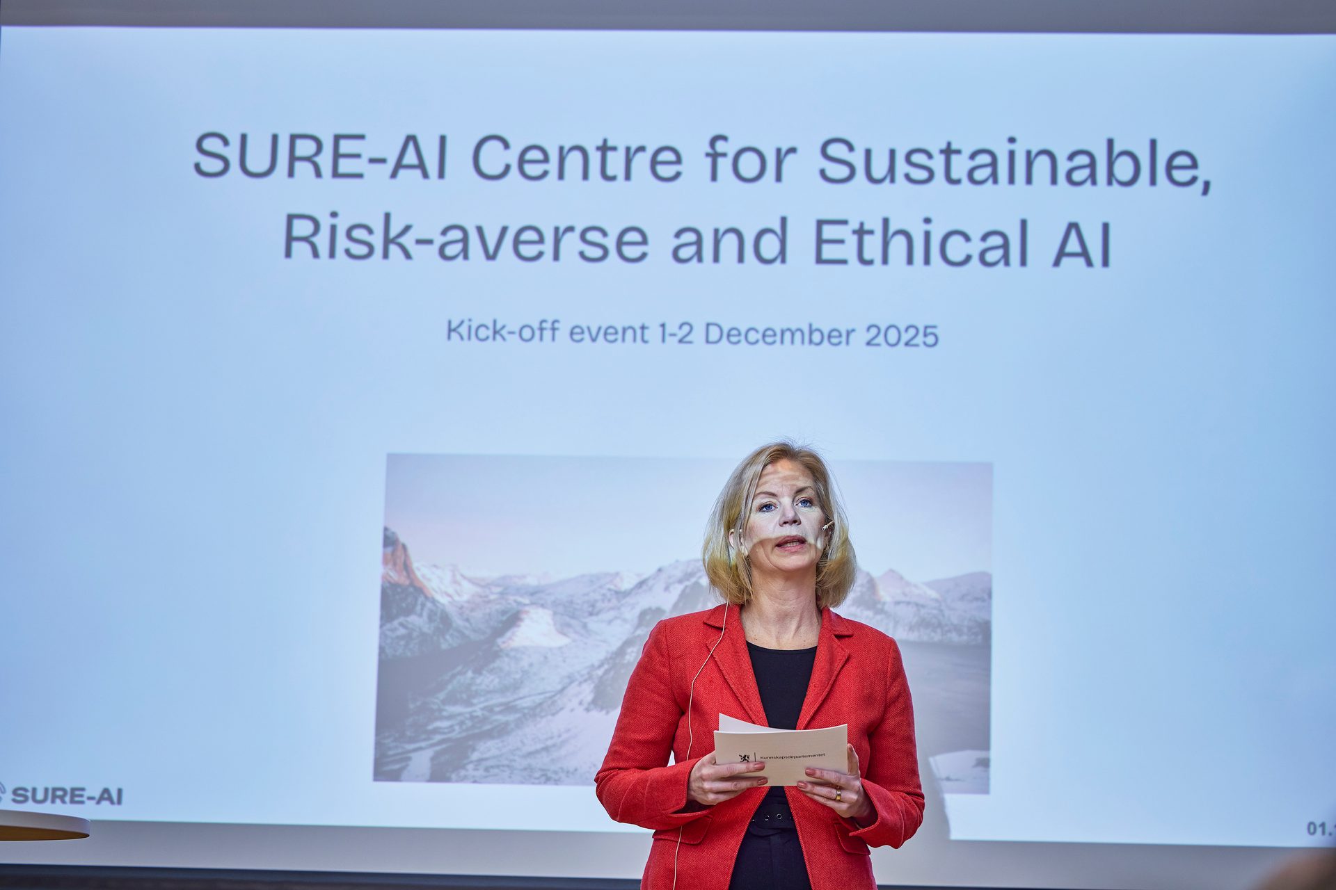 Woman presenting "SURE-AI Centre for Sustainable, Risk-averse and Ethical AI" at a kick-off event.