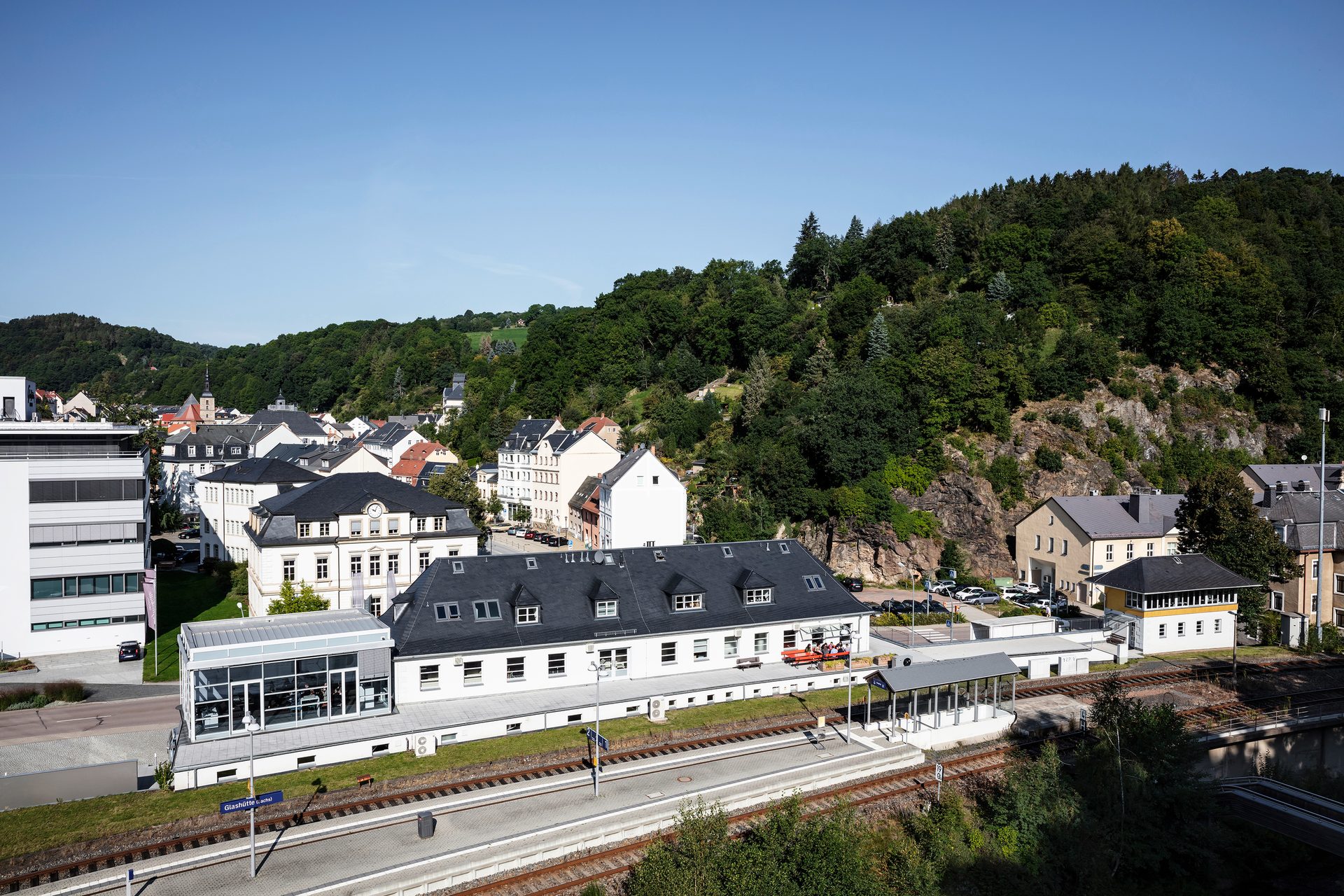 Urban design, Sky, Building, Mountain, Tree, Plant, Train