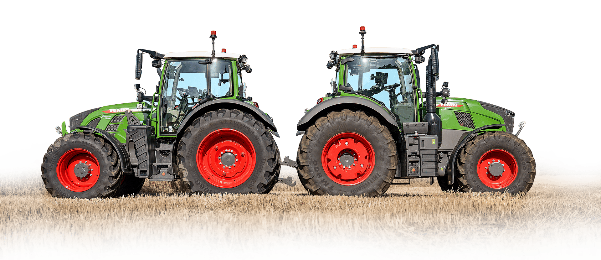 Two green Fendt tractors with red wheels in a stubble field, side view.
