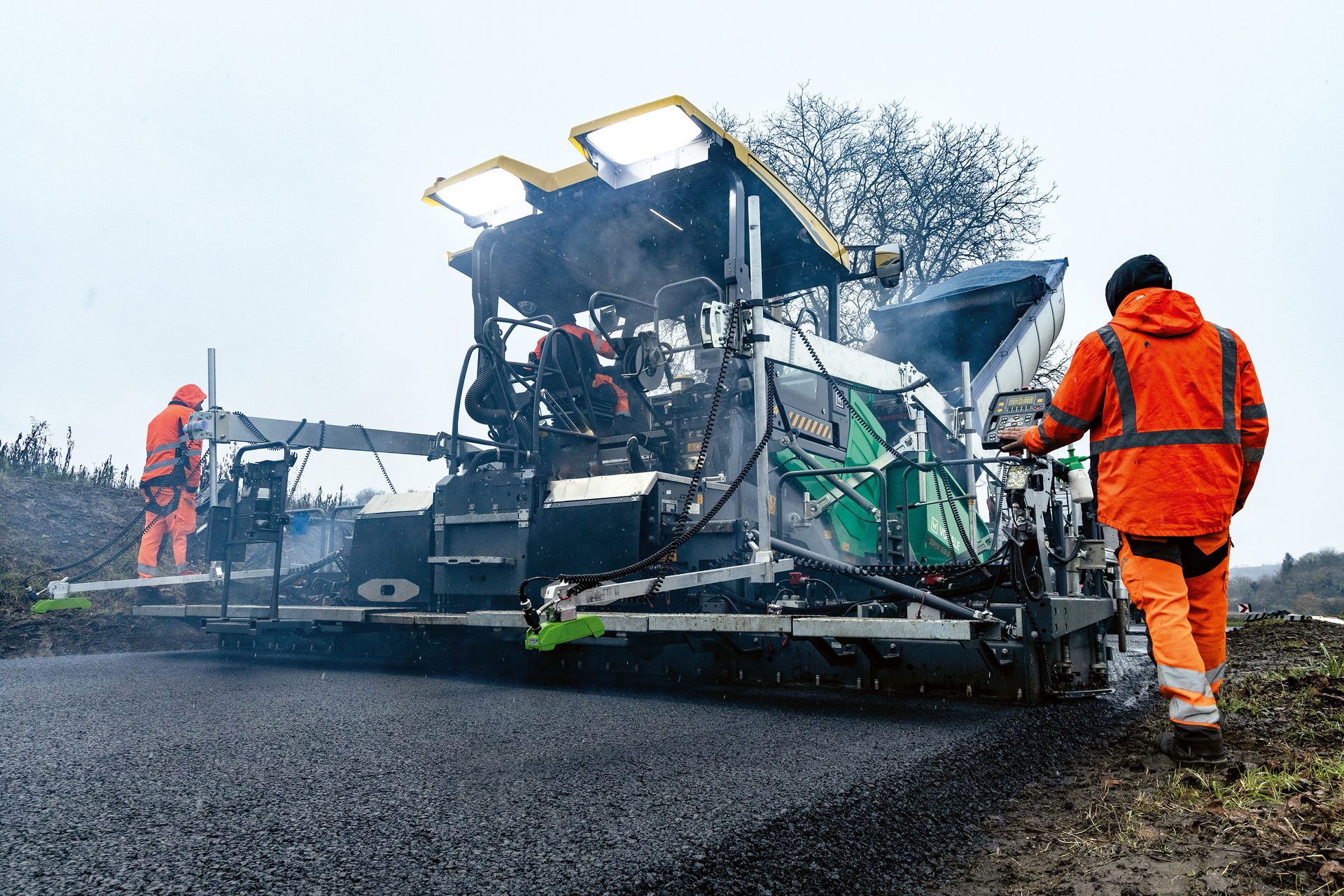 Motor vehicle, Road surface, High-visibility clothing, Automotive tire, Sky, Workwear, Wheel, Asphalt