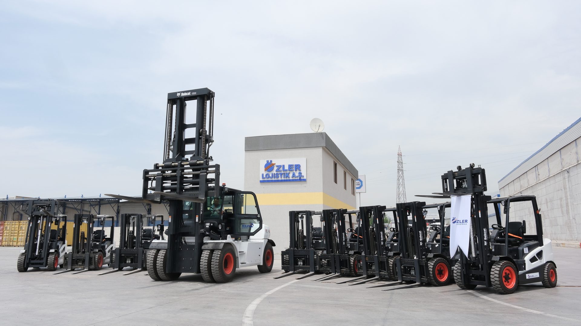 A fleet of Bobcat forklifts parked at Özler Lojistik A.Ş. facility.