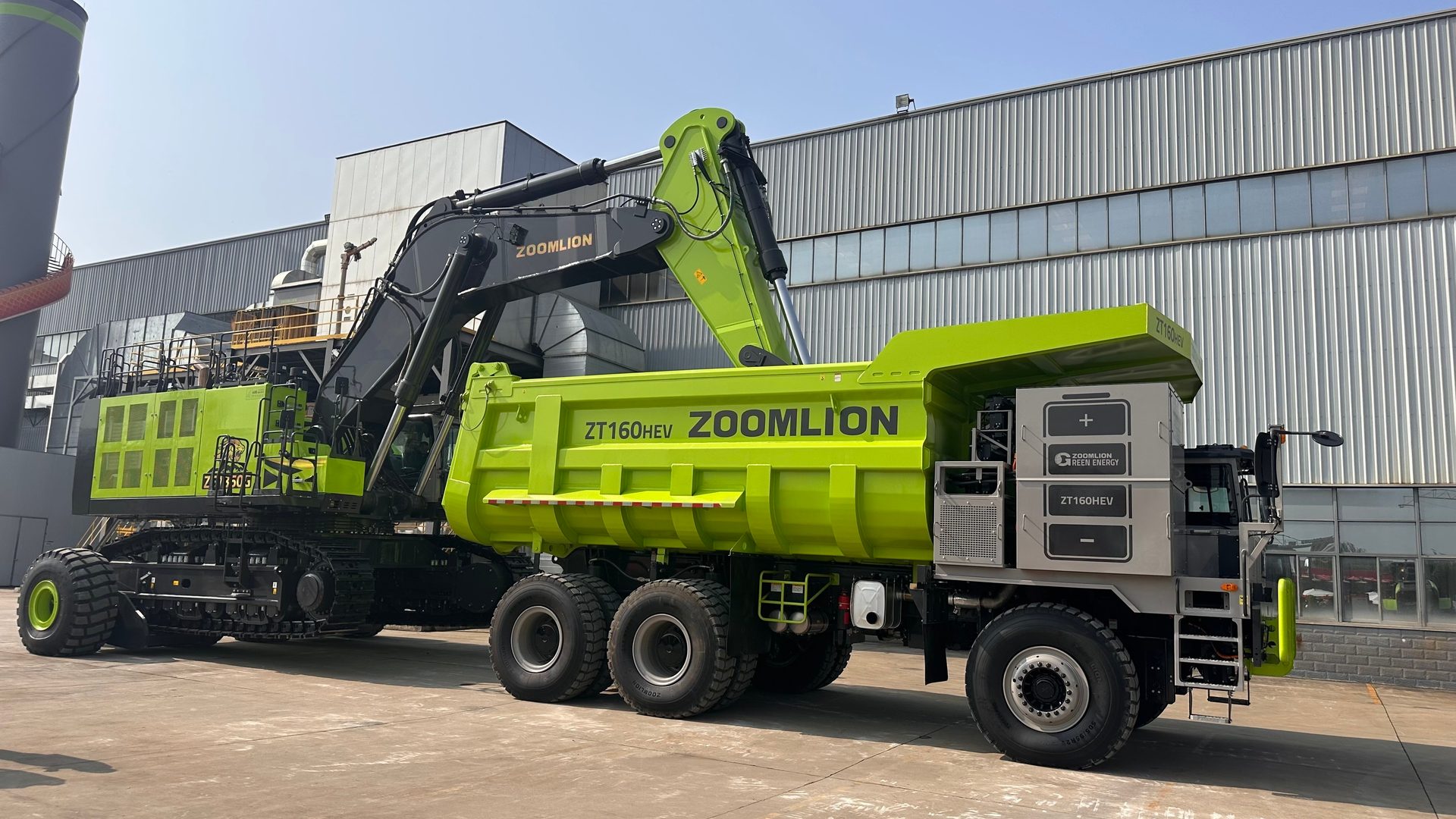 Lime green Zoomlion excavator and ZT160HEV hybrid dump truck.