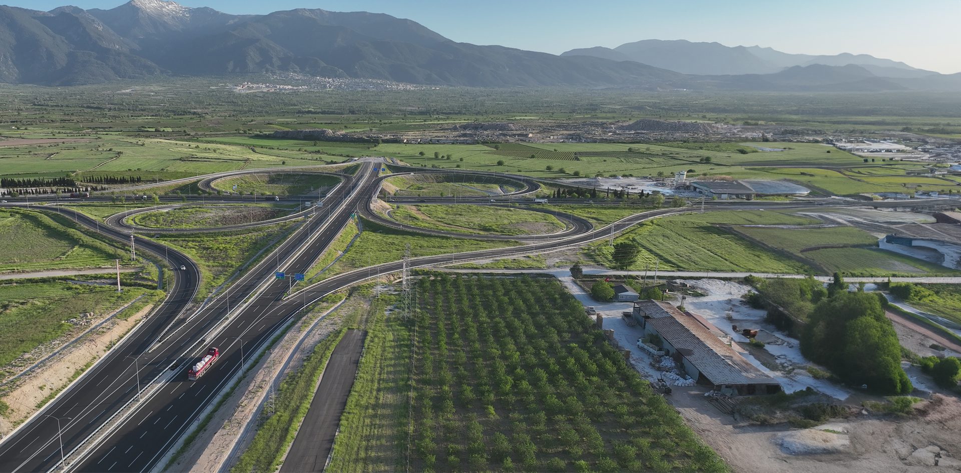 Water resources, Natural landscape, Land lot, Urban design, Road surface, Plant, Sky, Mountain, Asphalt