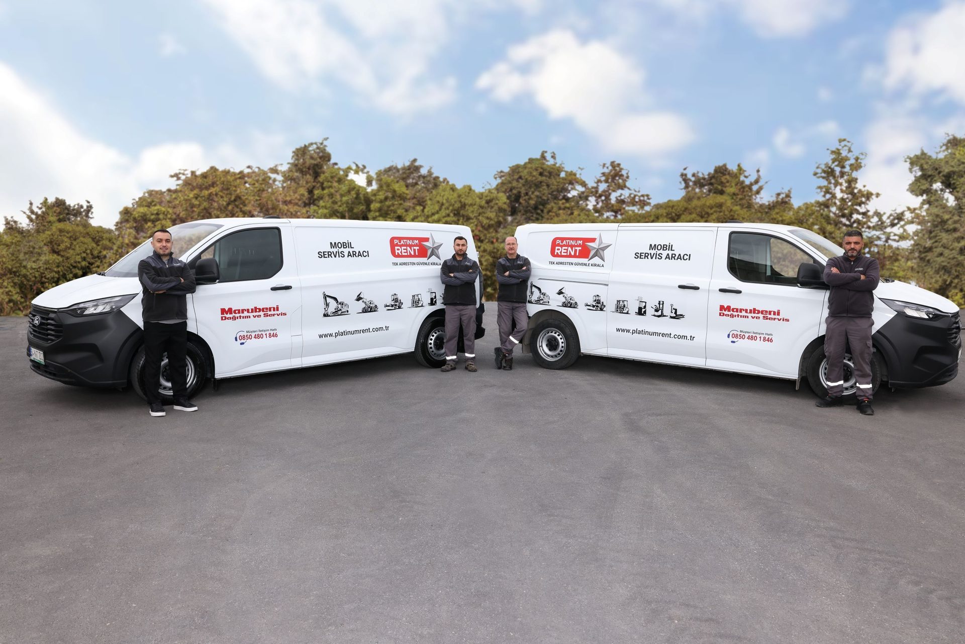 Three men stand with two white "Platinum Rent" and "Marubeni" branded service vans.
