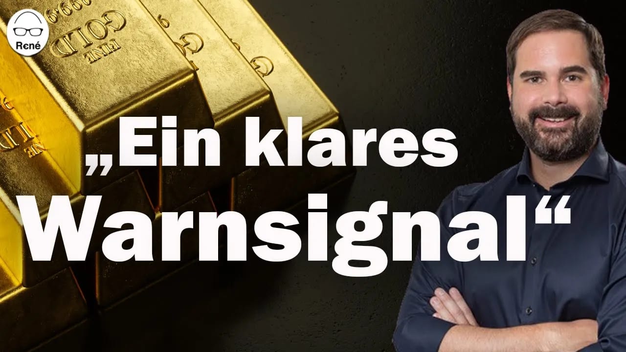 Smiling man with a beard next to gold bars, text reads "Ein klares Warnsignal" (A clear warning sign).