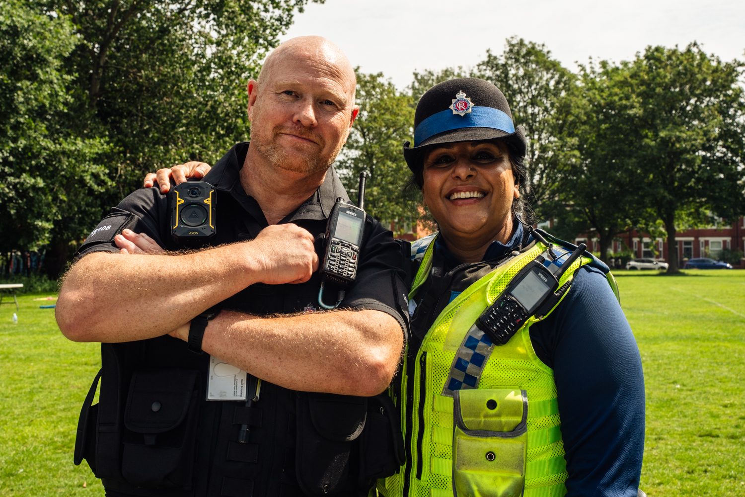 Photo of 2 police officers smiling a the camera