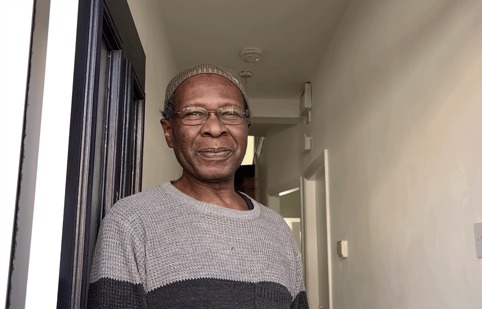 Resident Alan, smiling at camera