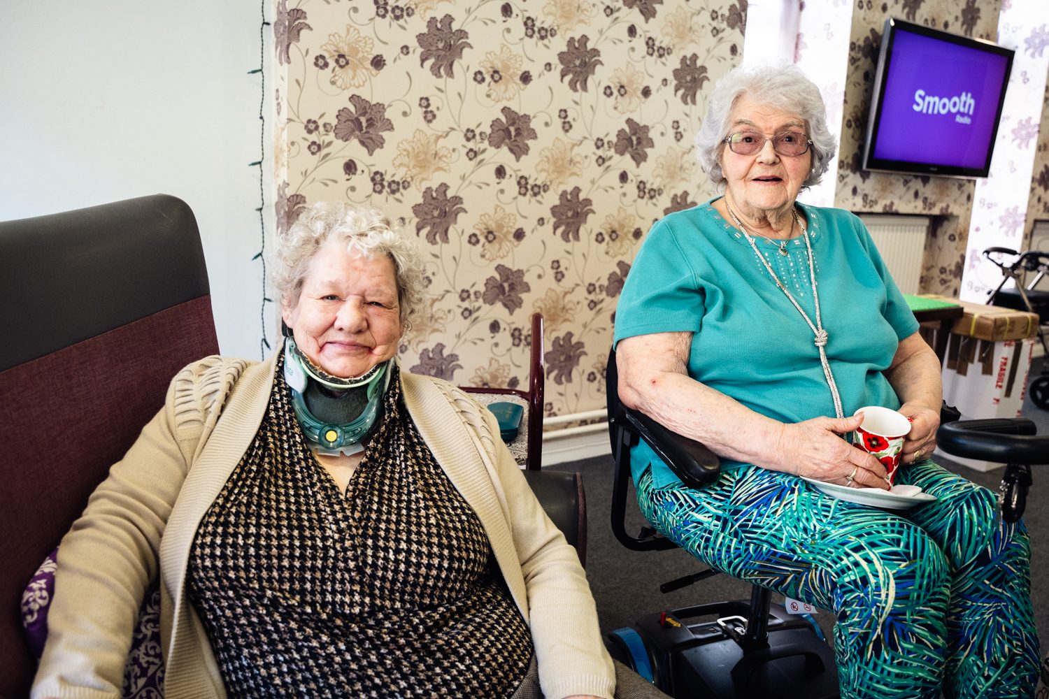 Photo of 2 older residents sitting together and smiling at msv scheme