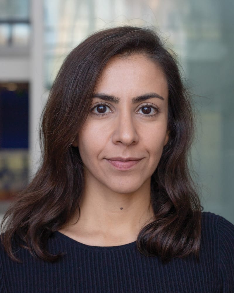 Headshot of a young woman with dark brown hair and eyes, looking at the camera.