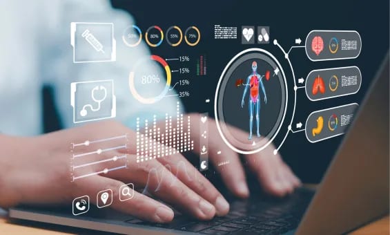 Hands typing on a laptop with a holographic display showing medical data and human anatomy.