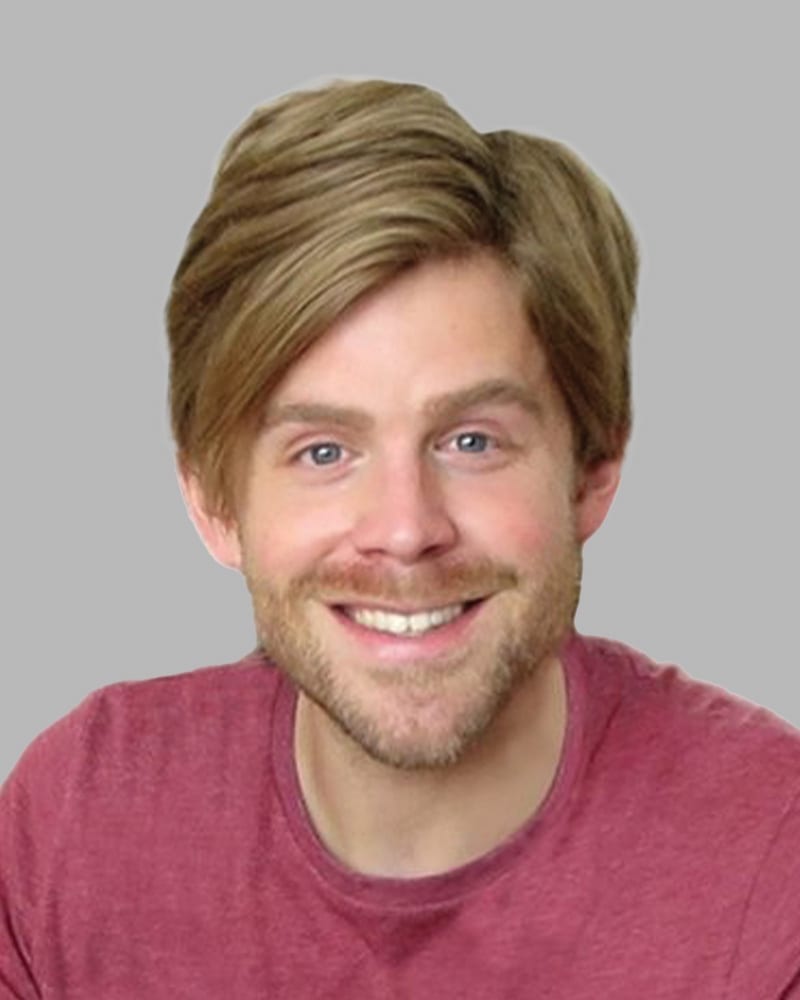 Smiling man with blonde hair, beard, and red shirt.