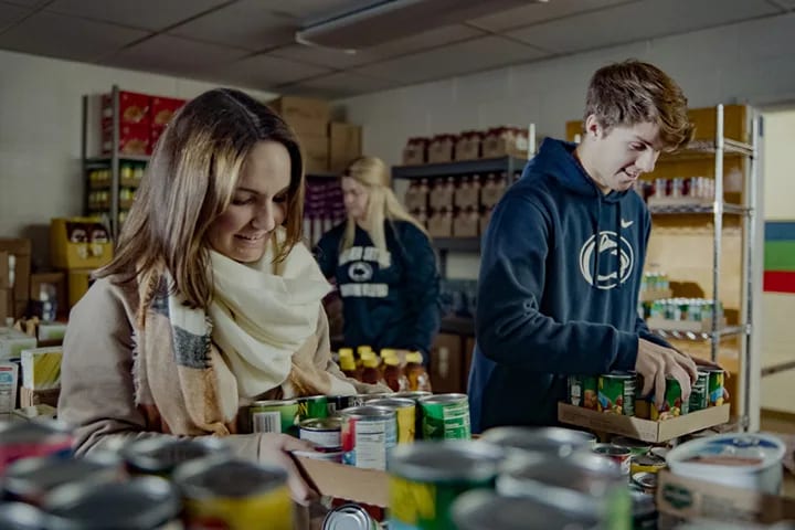 Volunteers organize canned goods at a food pantry.