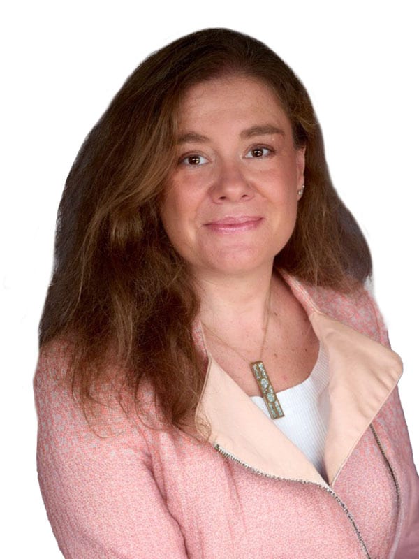 Smiling woman with long brown hair and a pink textured jacket.
