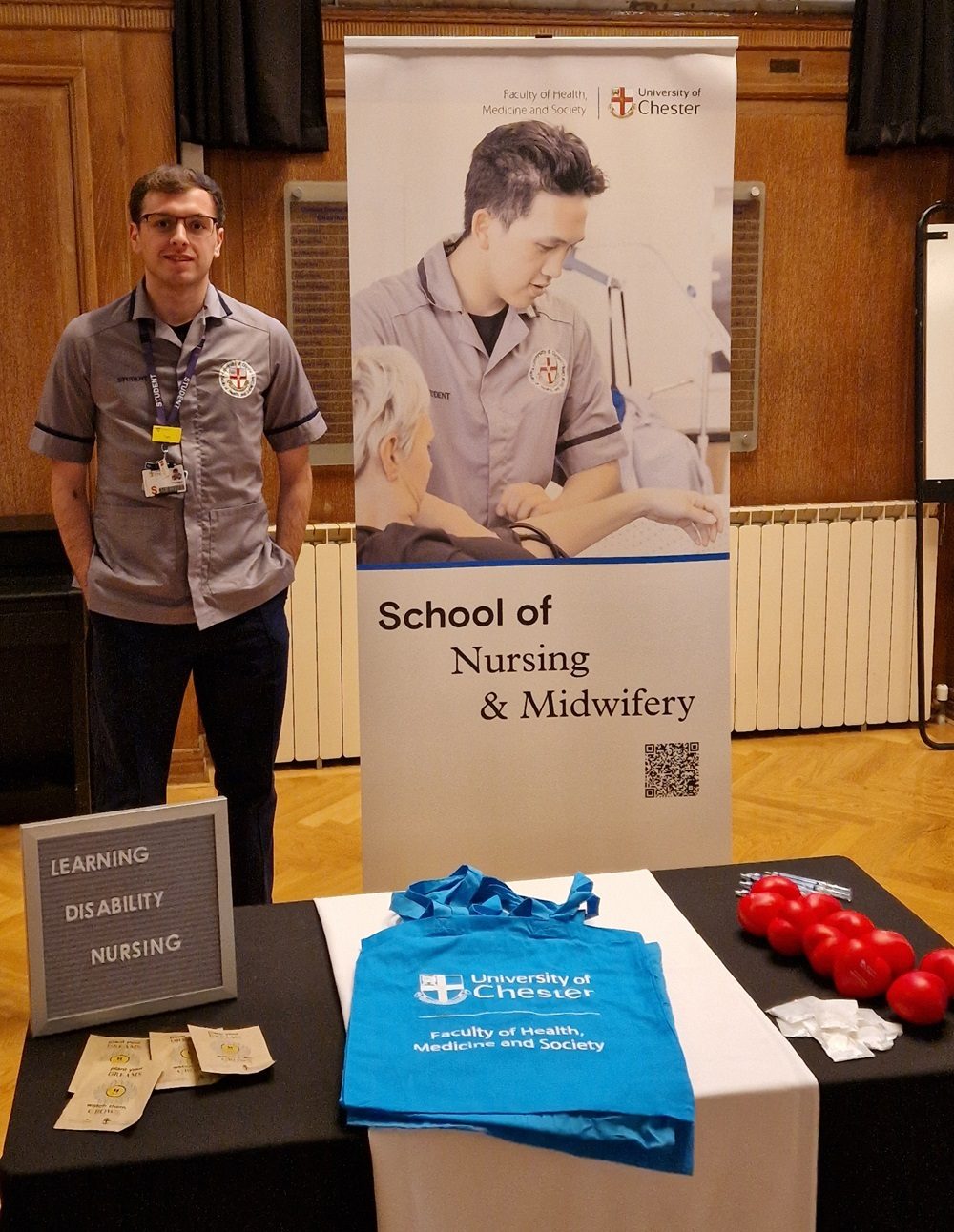 Male student nurse at a University of Chester Nursing & Midwifery recruitment stand.
