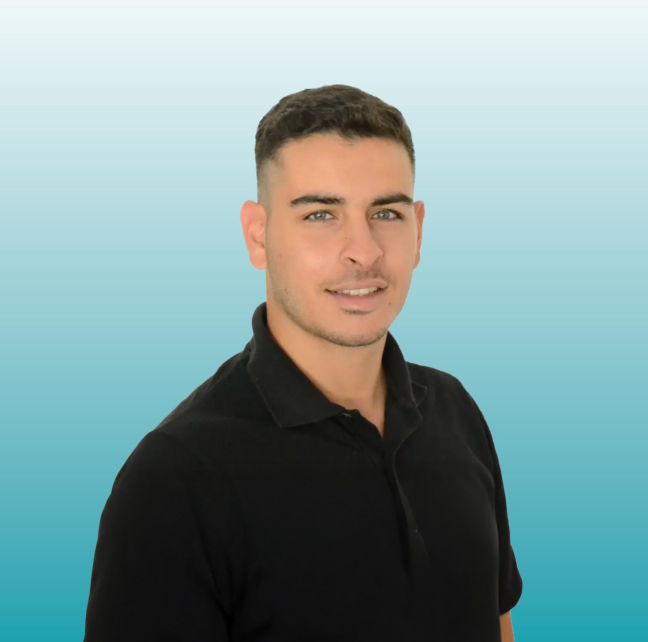 Smiling man in a black polo shirt with short hair against a blue background.