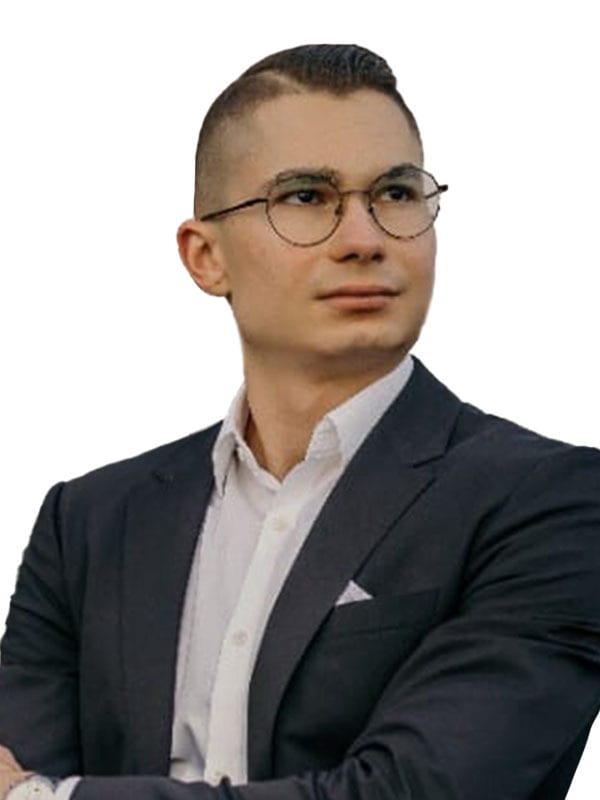 Man in suit and glasses, looking right.