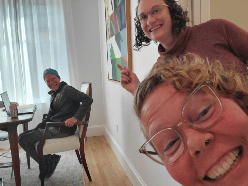 Interior design, Facial expression, Smile, Glasses, Shoulder, Happiness, Furniture, Flooring, Wrist, Sitting