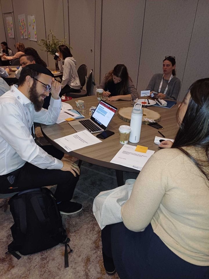 Furniture, Table, Shirt, Chair, Desk, Sitting, Drinkware, Interaction, Sharing, Meeting