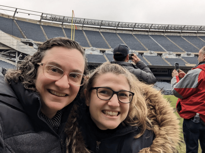 Sports venue, Facial expression, Smile, Happiness, Jacket, Stadium, Fun, Leisure