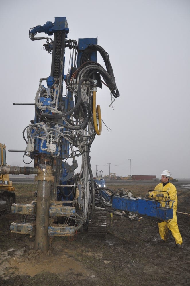 Automotive tire, Motor vehicle, High-visibility clothing, Hard hat, Sky, Wheel, Asphalt, Workwear