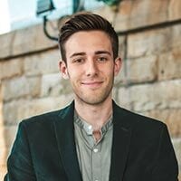 Forehead, Head, Smile, Neck, Jaw, Sleeve, Gesture, Collar, Beard, Suit