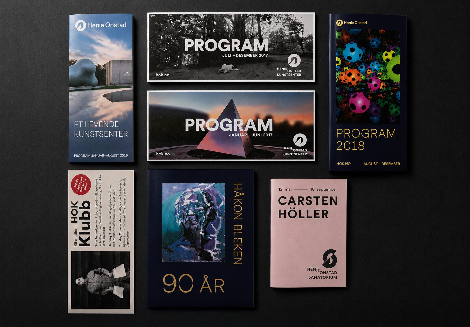 A flat lay of various promotional materials, brochures, and program covers for the Henie Onstad art center.