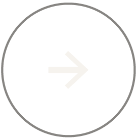 A light gray right arrow inside a thin gray circle, centered on a white background.